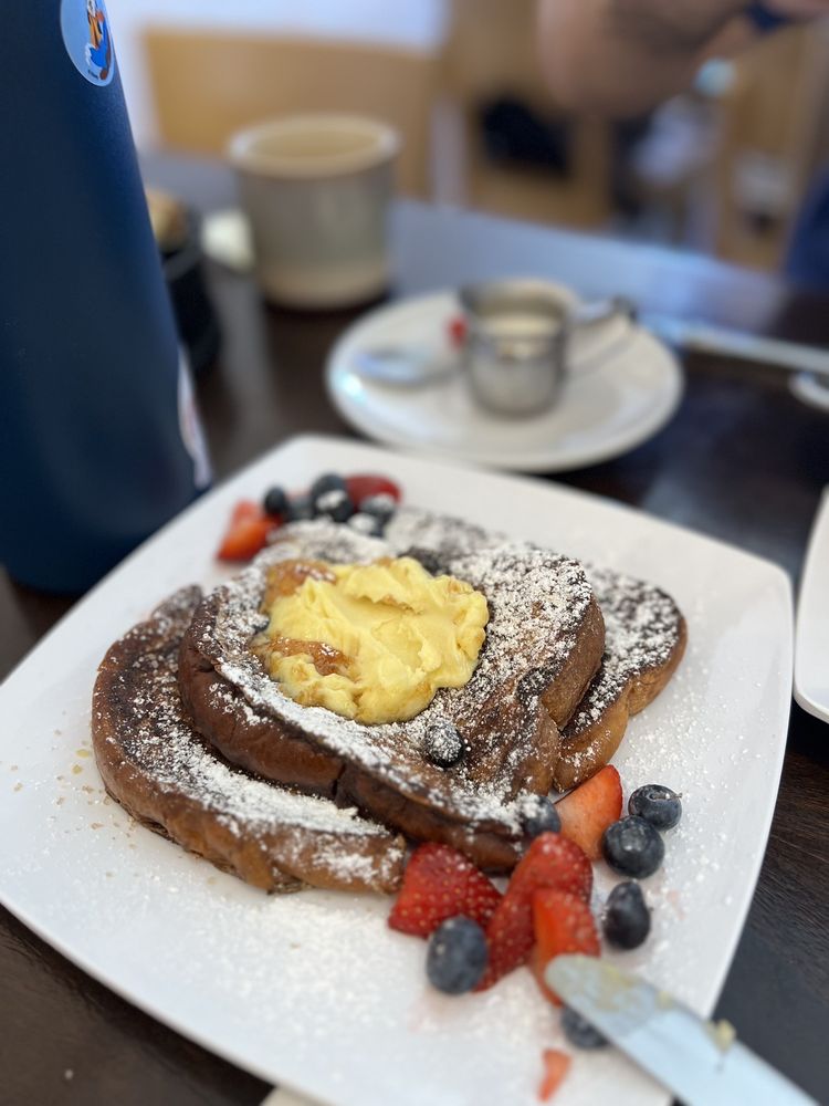 Crème brûlée french toast with caramelized sugar and fresh berries